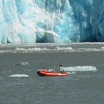Orange vessel surrounded by icebergs