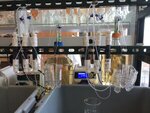 Small scale laboratory columns with peristaltic pumps and influent containers in background.